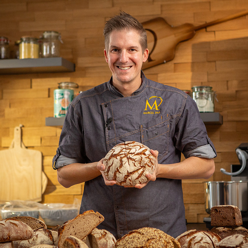 Marcel hält ein Brot in der Hand