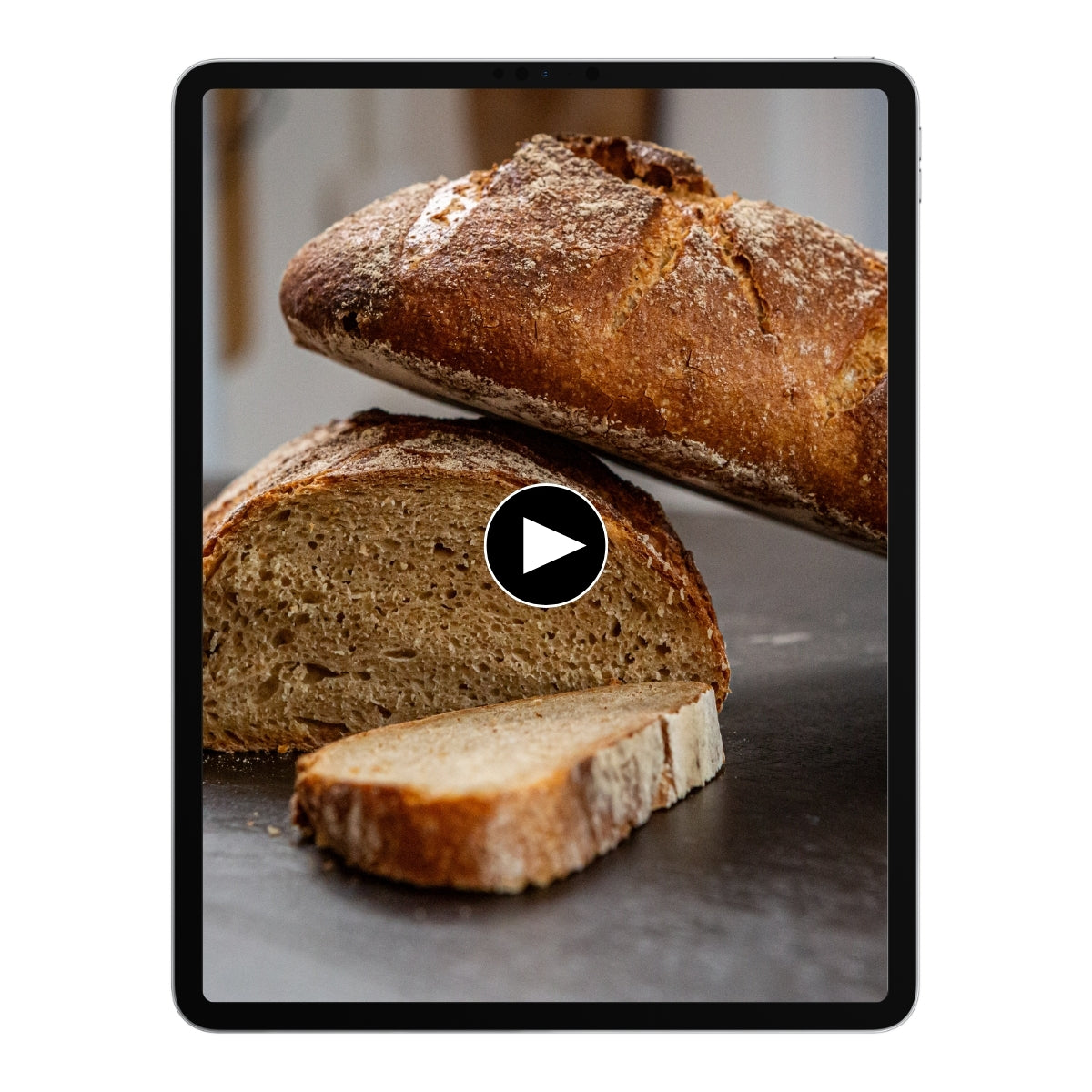 Brotlaib und Brotscheiben auf einem Tablet